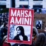 Demonstrators in front of the Brandenburg Gate in Berlin express their solidarity with Mahsa Amini