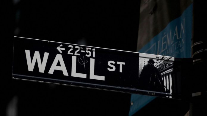 FILE PHOTO : A Wall St. street sign is seen near the New York Stock Exchange (NYSE) in New York City, U.S., September 17, 2019. REUTERS/Brendan McDermid//File Photo