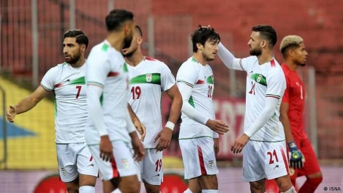 Sardar Azmoun (3rd from right) gets his head stroked by a fellow player