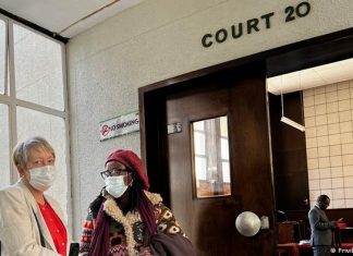Author Tsitsi Dangarembga found guilty | Books | DW Julie Barnes and Tsitsi Dangarembga wearing face masks outside the courtroom in Harare