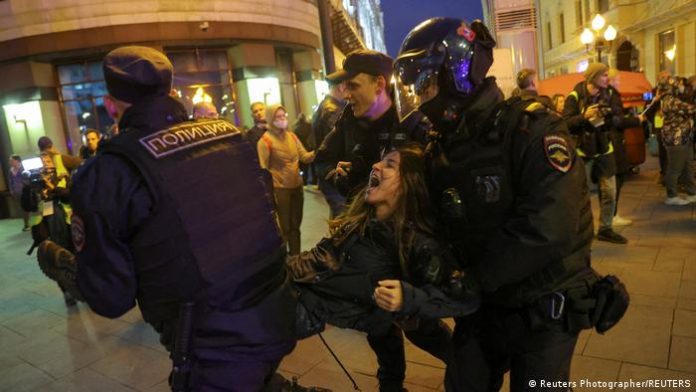 Security forces carry away a protester 